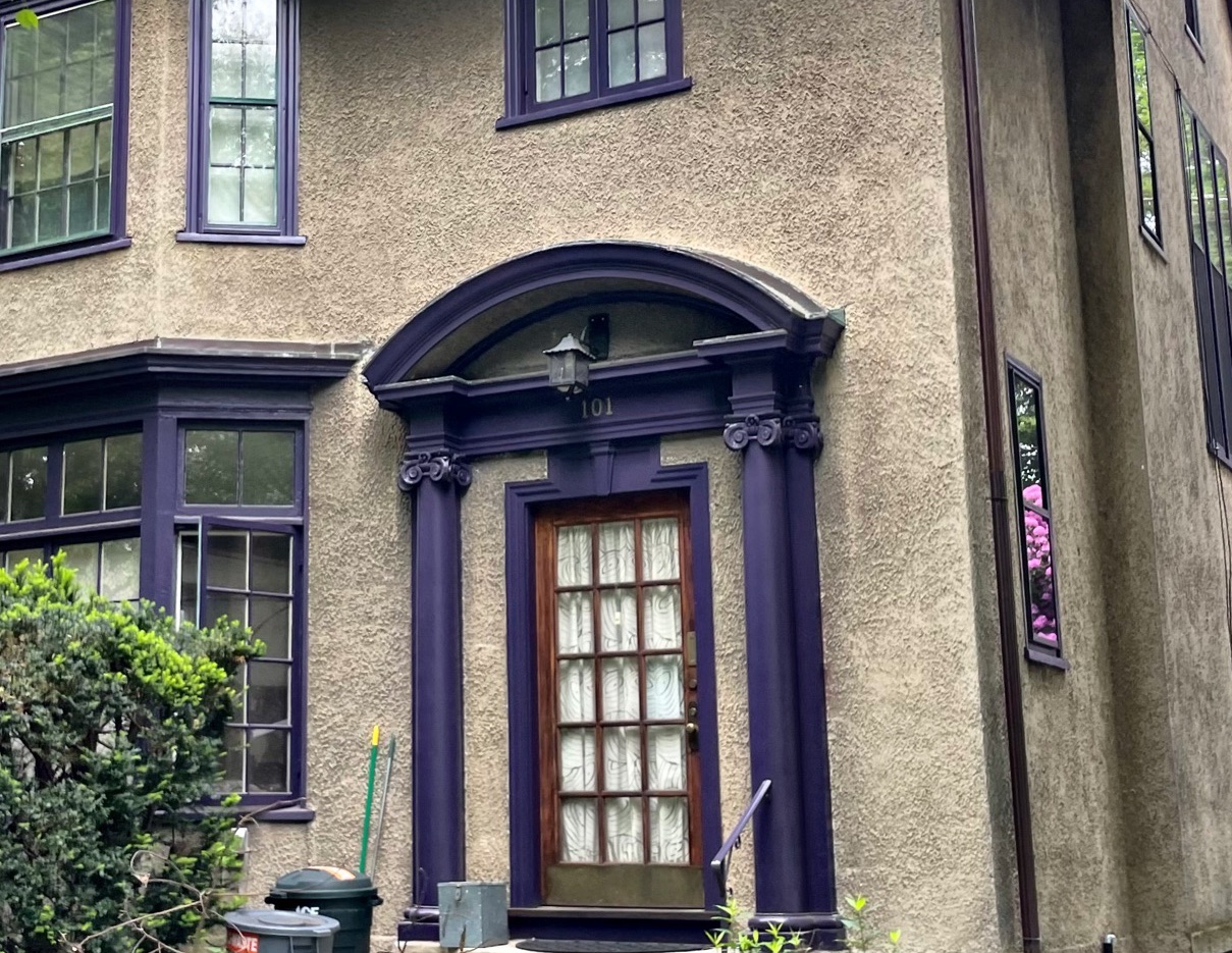 A zoomed in image of the border of a door of a neoeclectic house.